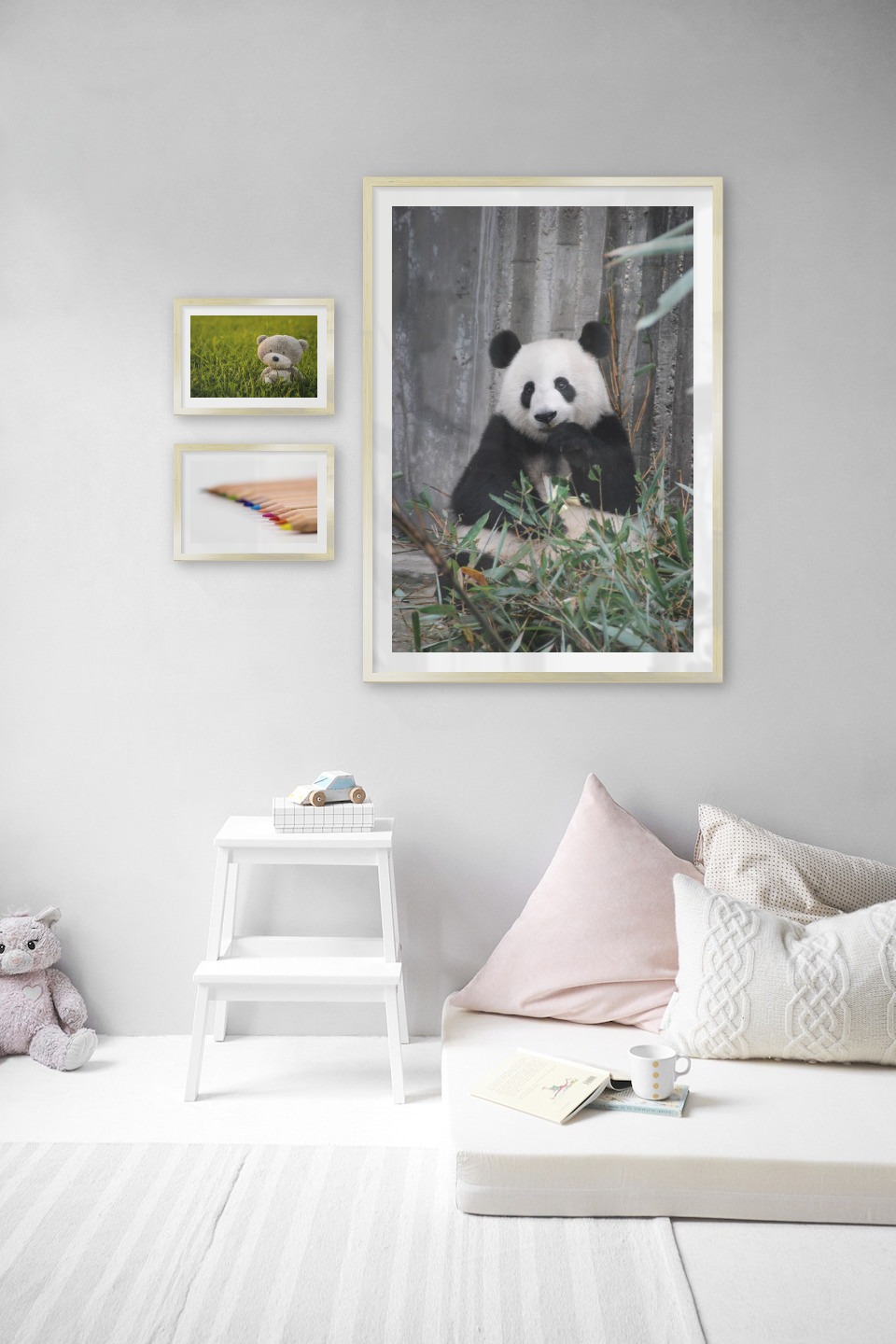 Tavelvägg med ramar i guld i storlekar 21x30 och 70x100 med posters med "Nalle i ett fält", "Pennor i olika färger" och "Panda"