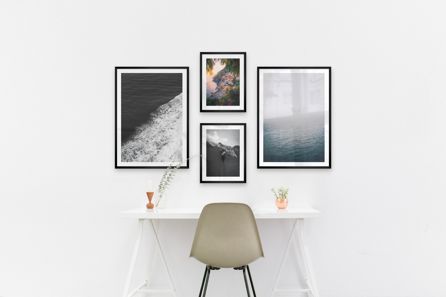 Tavelvägg med ramar i svart i storlekar 50x70 och 30x40 med posters med "Svall från vågor", "Stad vid havet", "Sköldpadda" och "Dimma över havet"